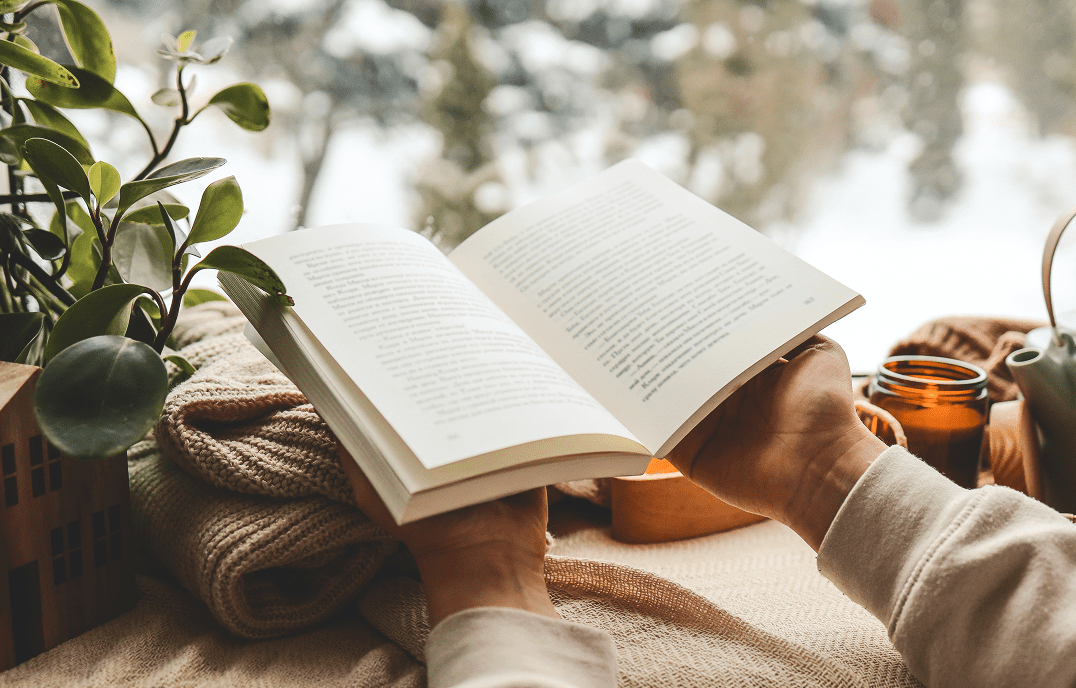 Reading a book by the window
